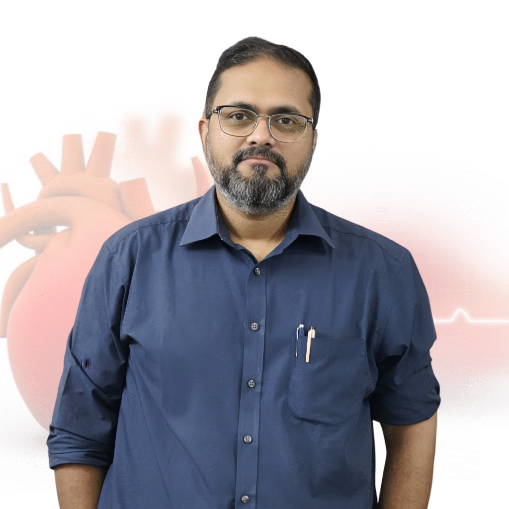 A male doctor wearing glasses and a blue shirt standing in front of a medical-themed background featuring a heart illustration.
